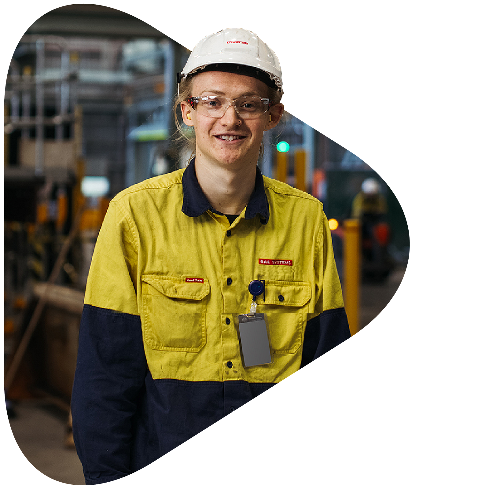 Defence apprentice onsite smiling in a construction hat and uniform