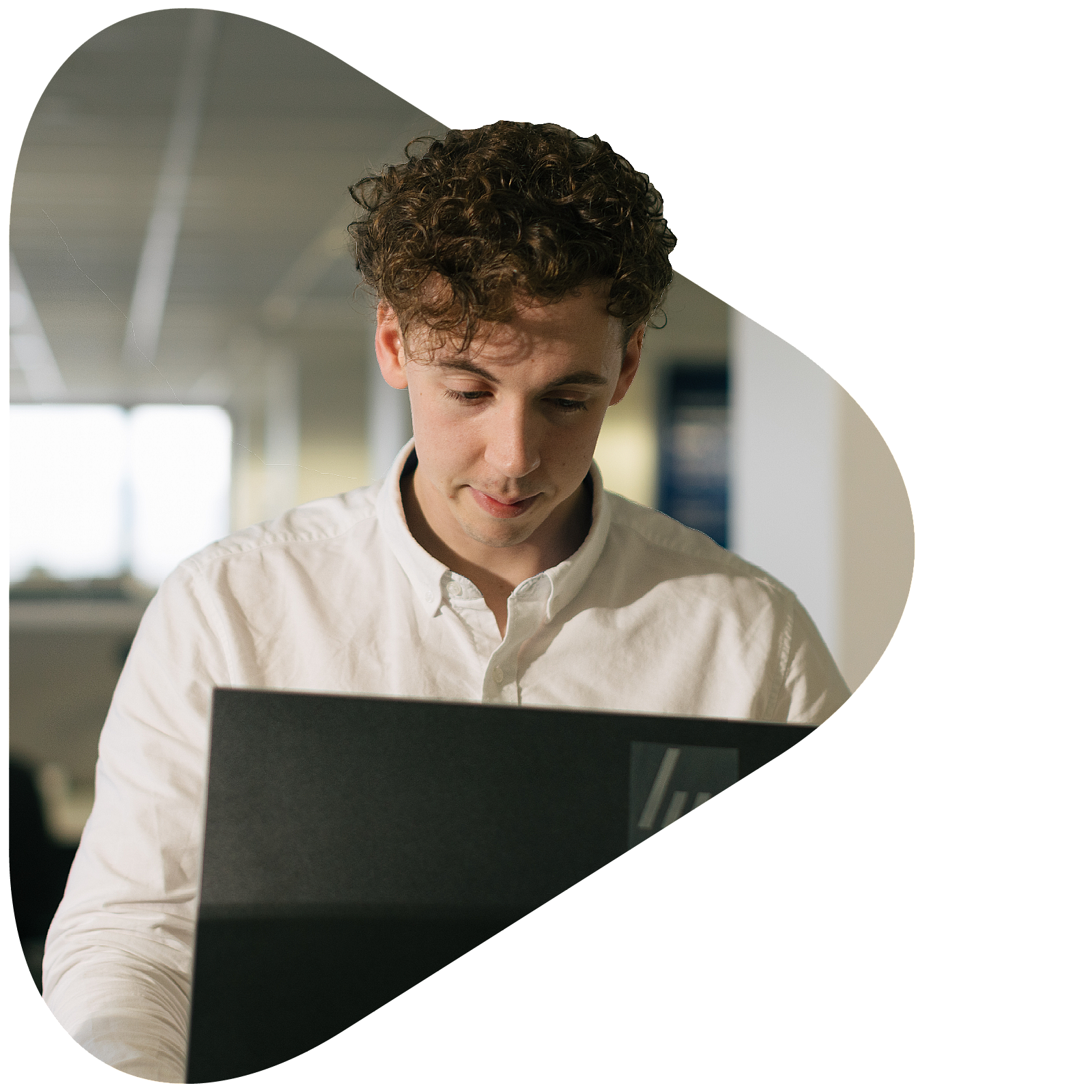 Information Technology apprentice looking down at laptop