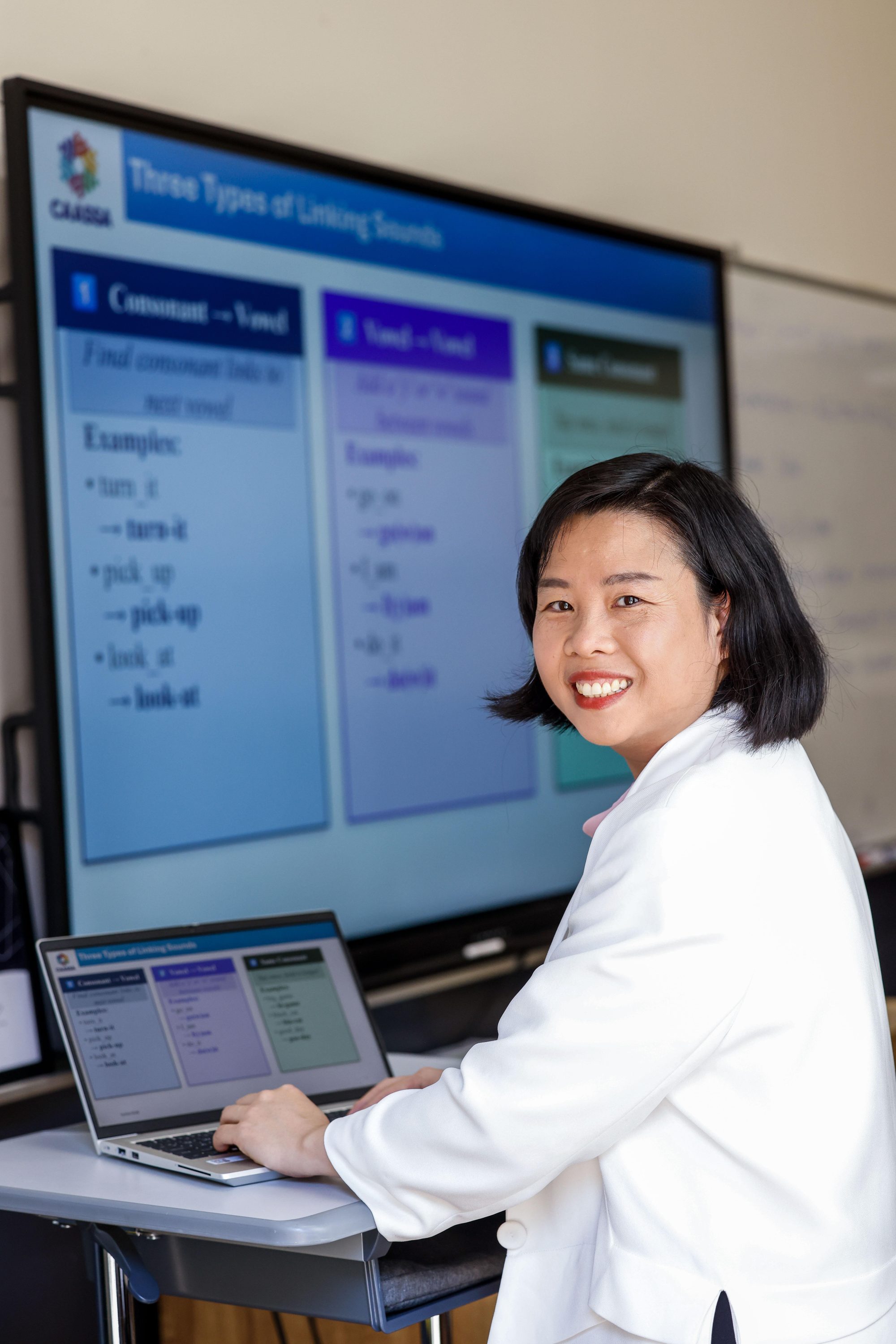 Student with laptop and smartboard